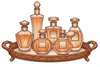Set of six amber-colored perfume bottles on an ornate wooden tray with a white background